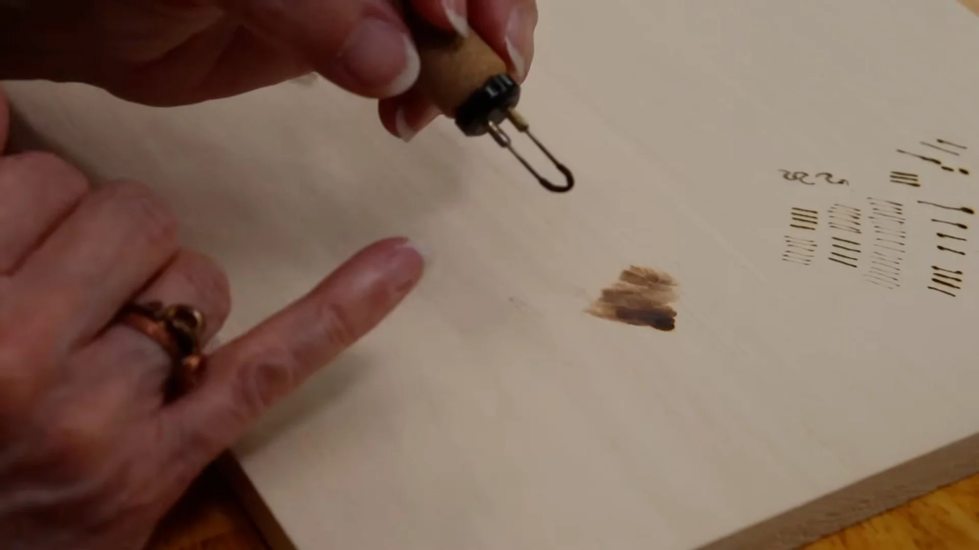 Blotchy overburned patch on a practice board — a common woodburning mistake