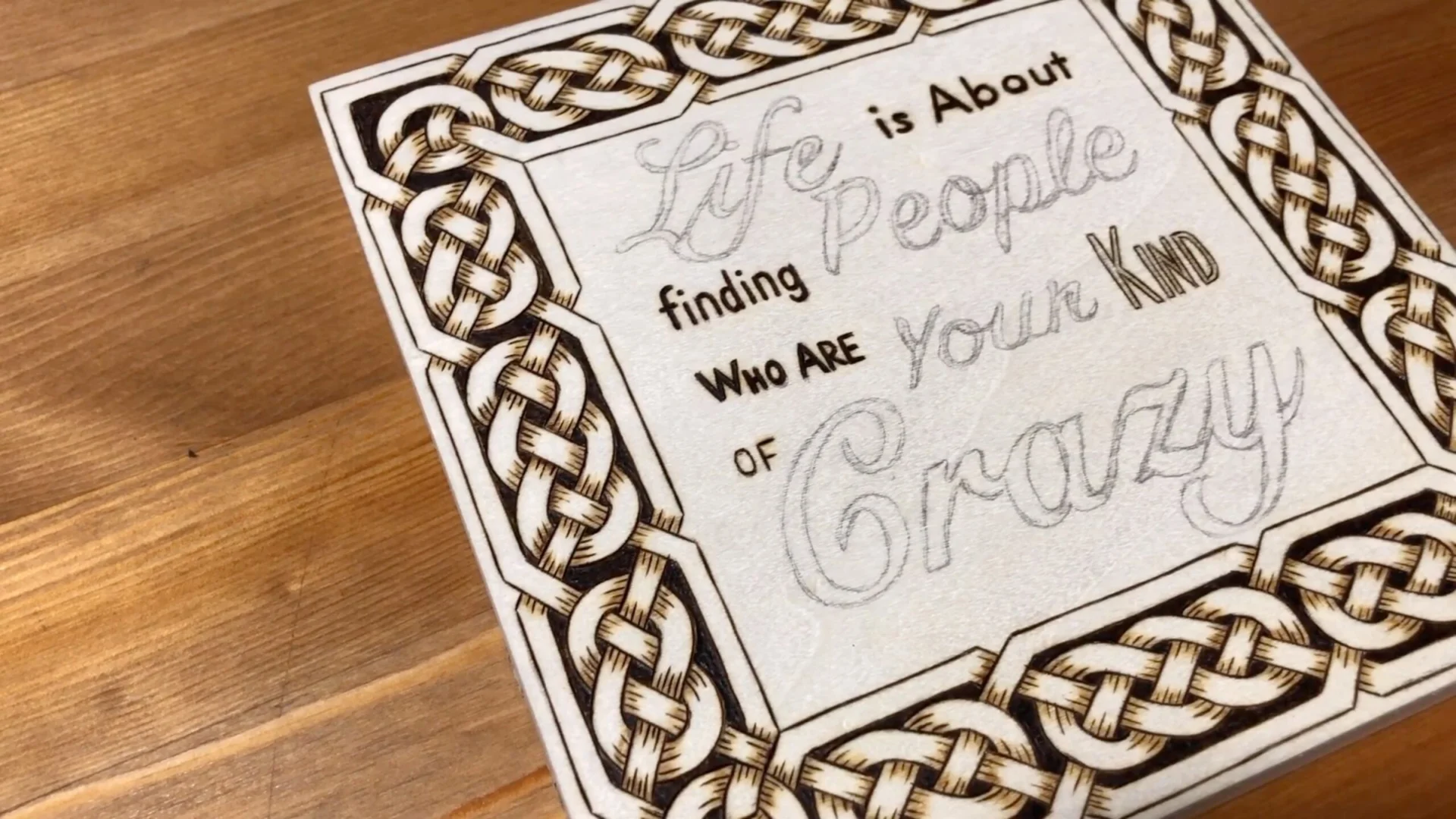 Hand-lettered quote with Celtic knot border burned on a wooden box lid