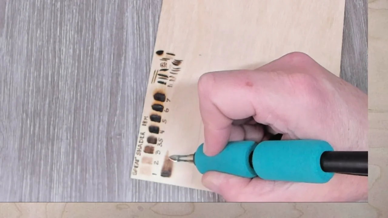A shading nib builds a light-to-dark test strip beside labelled burn samples