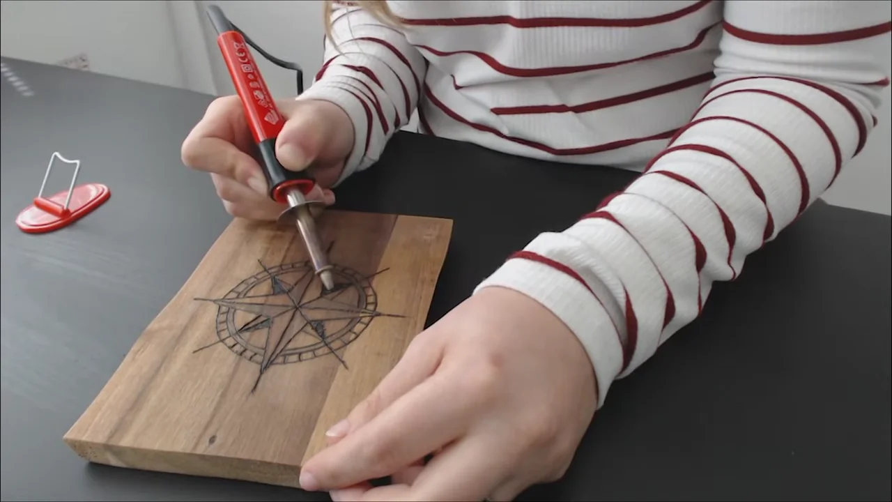 Filling the triangular sections of a compass design with a solid-point burner