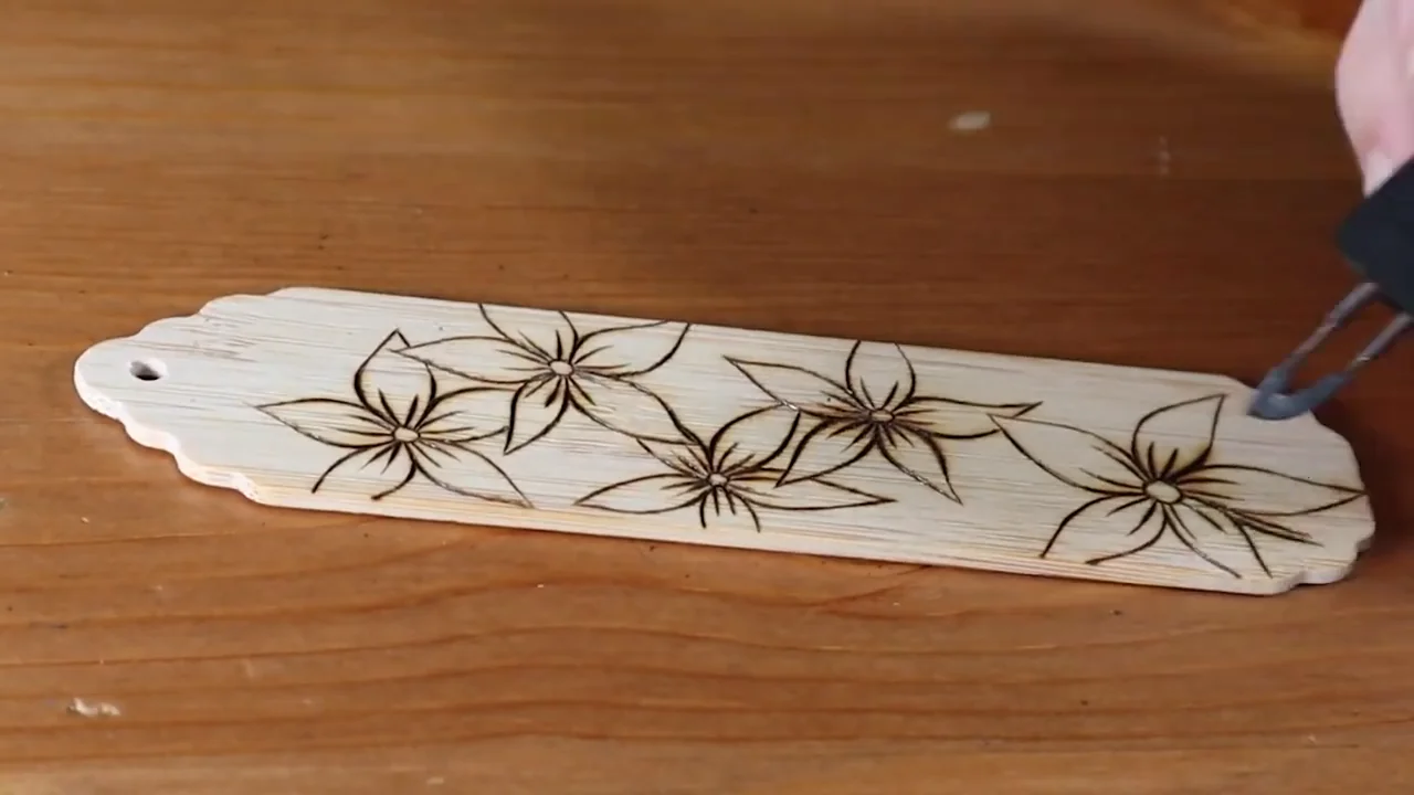 Burning a floral outline along a narrow bookmark