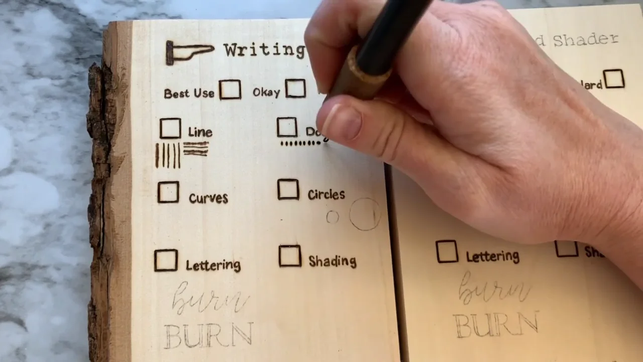 Making a row of small stippled dots on a wood-burning practice board
